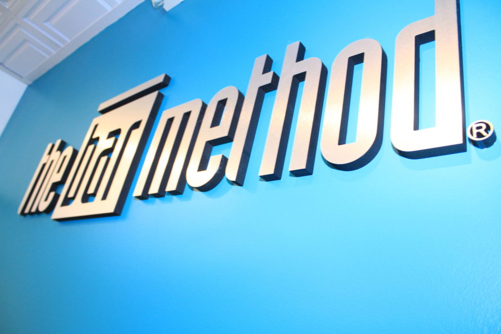 bar Method logo behind front desk at at The Bar Method Studio City