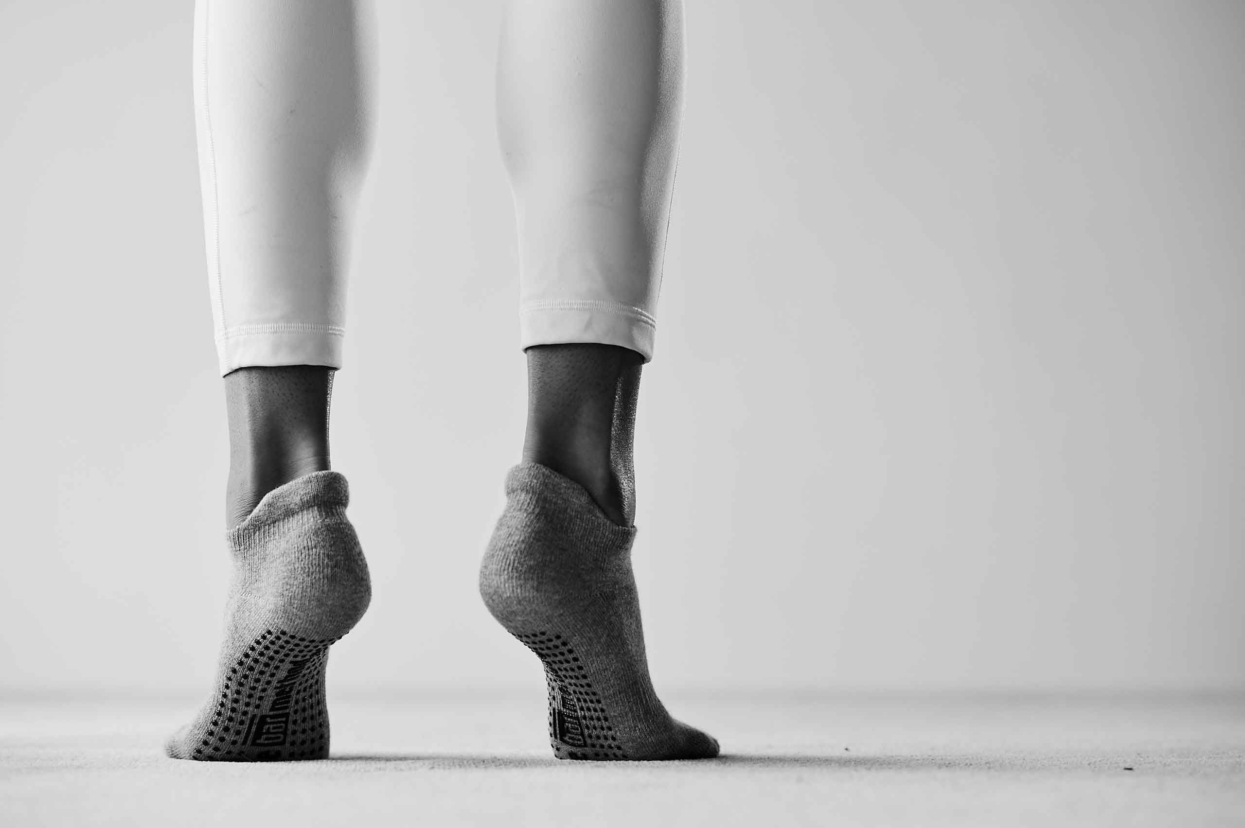 Black and white image of two feet on its toes