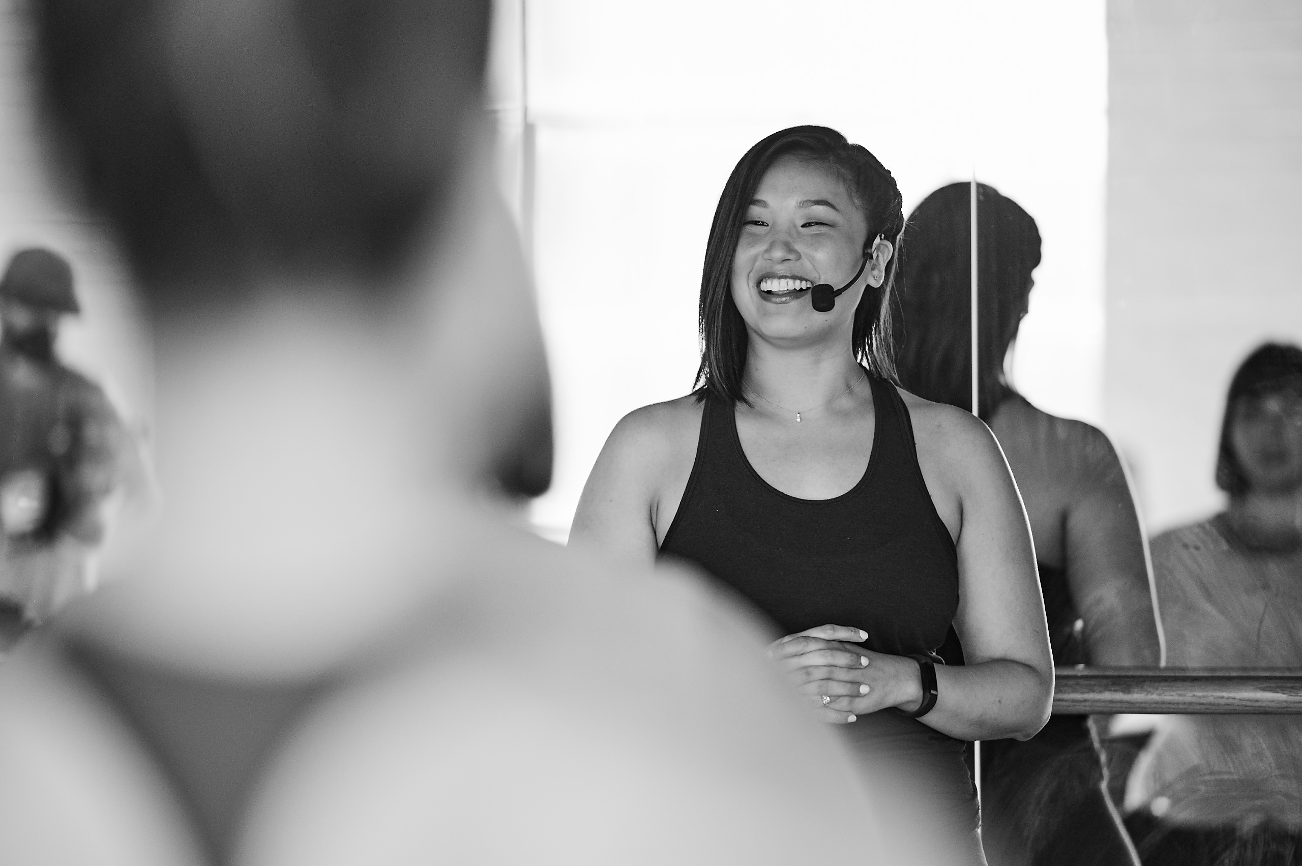 Black and white image of instructor teaching class and smiling