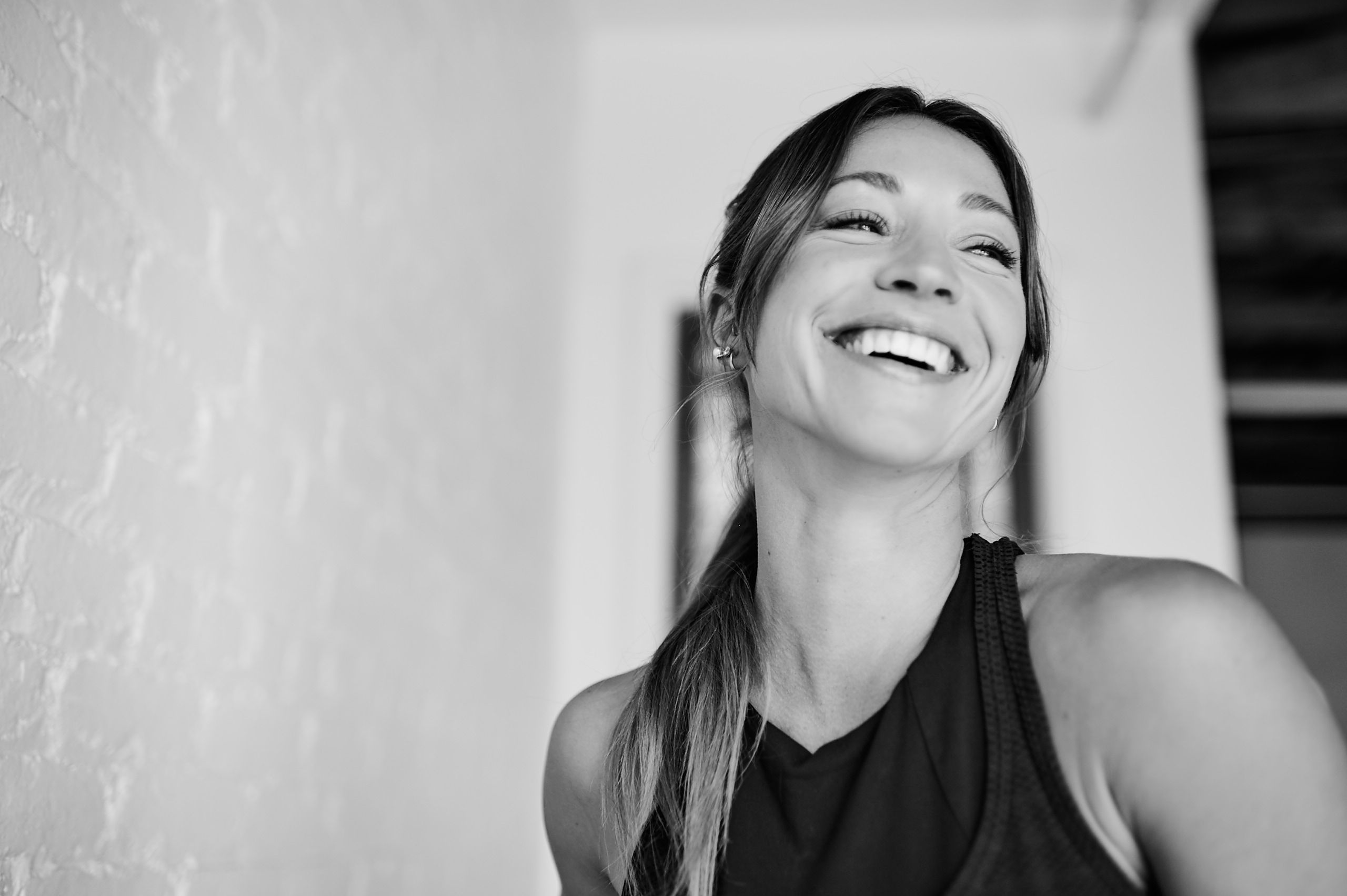 Black and white image of woman smiling in a Bar Method Studio